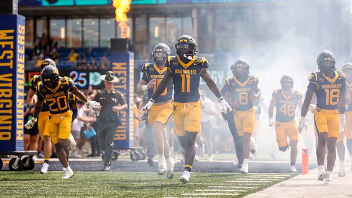 Sep 12, 2026; Morgantown, West Virginia, USA; The West Virginia Mountaineers run onto the field before their game against the UT Martin Skyhawks at Milan Puskar Stadium. Mandatory Credit: Ben Queen-Imagn Images Sep 12, 2026; Morgantown, West Virginia, USA; The West Virginia Mountaineers run onto the field before their game against the UT Martin Skyhawks at Milan Puskar Stadium. Mandatory Credit: Ben Queen-Imagn Images