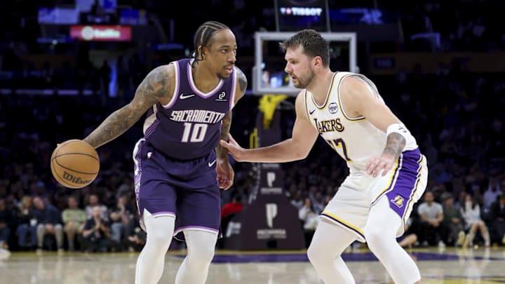 Mar 1, 2026; Los Angeles, California, USA; Sacramento Kings guard DeMar DeRozan (10) dribbles the ball against Los Angeles Lakers guard Luka Doncic (77) during the second quarter at Crypto.com Arena.