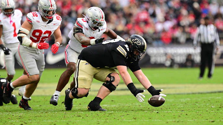 Nov 8, 2025; West Lafayette, Indiana, USA; Purdue Boilermakers offensive lineman Hank Purvis (58) attempts to recover a fumble during the second quarter against the Ohio State Buckeyes at Ross-Ade Stadium. Mandatory Credit: Marc Lebryk-Imagn Images Nov 8, 2025; West Lafayette, Indiana, USA; Purdue Boilermakers offensive lineman Hank Purvis (58) attempts to recover a fumble during the second quarter against the Ohio State Buckeyes at Ross-Ade Stadium. Mandatory Credit: Marc Lebryk-Imagn Images