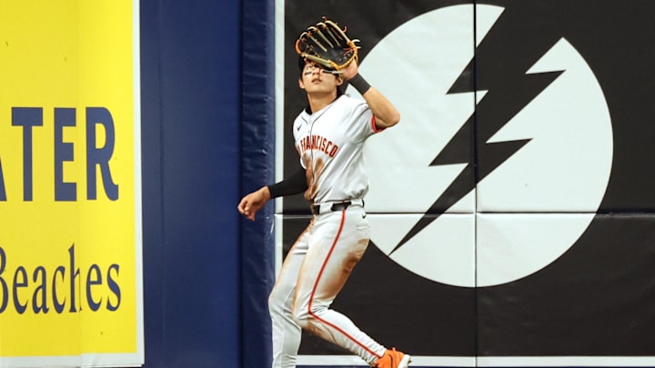 Apr 12, 2024; St. Petersburg, Florida, USA; San Francisco Giants outfielder Jung Hoo Lee (51) catches a fly ball against the Tampa Bay Rays during the third inning at Tropicana Field. Mandatory Credit: Kim Klement Neitzel-Imagn Images
