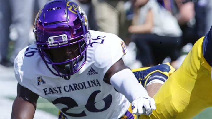 Sep 2, 2023; Ann Arbor, Michigan, USA; Michigan Wolverines running back Blake Corum (2) is forced out by East Carolina Pirates defensive back Isaiah Brown-Murray (26) in the first half at Michigan Stadium. Mandatory Credit: Rick Osentoski-Imagn Images
