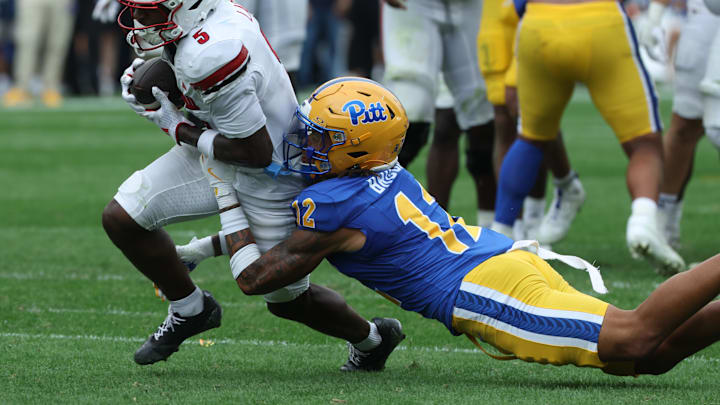 Sep 27, 2025; Pittsburgh, Pennsylvania, USA; Louisville Cardinals wide receiver Caullin Lacy (5) runs after a. catch against Pittsburgh Panthers defensive back Cruce Brookins (12) during the second quarter at Acrisure Stadium. Mandatory Credit: Charles LeClaire-Imagn Images Sep 27, 2025; Pittsburgh, Pennsylvania, USA; Louisville Cardinals wide receiver Caullin Lacy (5) runs after a. catch against Pittsburgh Panthers defensive back Cruce Brookins (12) during the second quarter at Acrisure Stadium. Mandatory Credit: Charles LeClaire-Imagn Images