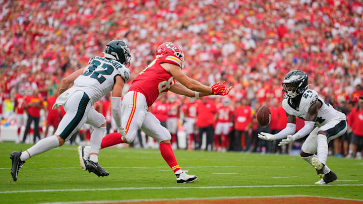 Sep 14, 2025; Kansas City, Missouri, USA; Philadelphia Eagles safety Andrew Mukuba (24) intercepts a pass intended for Kansas City Chiefs tight end Travis Kelce (87) during the fourth quarter of the game at GEHA Field at Arrowhead Stadium. Mandatory Credit: Jay Biggerstaff-Imagn Images