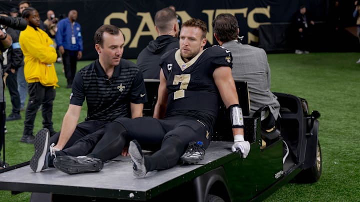 Dec 1, 2024; New Orleans, Louisiana, USA; New Orleans Saints tight end Taysom Hill (7) leaves the field after an injury against the Los Angeles Rams during the second half at Caesars Superdome. Mandatory Credit: Matthew Hinton-Imagn Images