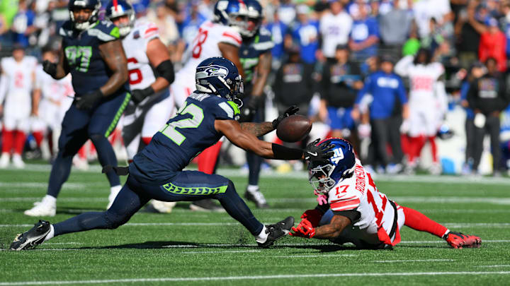 Oct 6, 2024; Seattle, Washington, USA; Seattle Seahawks cornerback Tre Brown (22) breaks up a pass intended for New York Giants wide receiver Wan'Dale Robinson (17) during the first half at Lumen Field. Mandatory Credit: Steven Bisig-Imagn Images