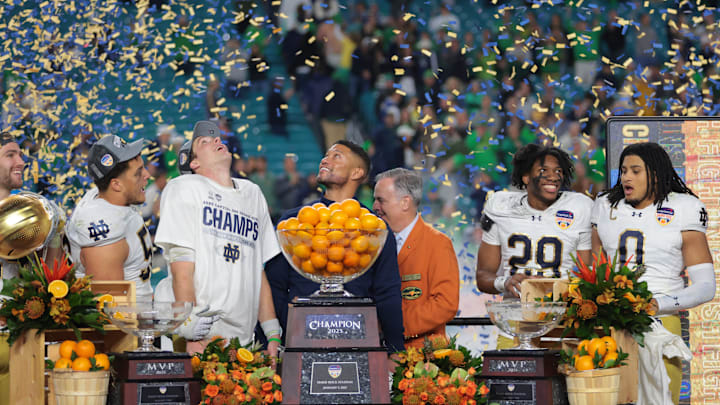 Jan 9, 2025; Miami, FL, USA; Notre Dame Fighting Irish head coach Micah Shrewsberry and quarterback Riley Leonard (13) celebrates defeating the Penn State Nittany Lions in the Orange Bowl at Hard Rock Stadium. Jan 9, 2025; Miami, FL, USA; Notre Dame Fighting Irish head coach Micah Shrewsberry and quarterback Riley Leonard (13) celebrates defeating the Penn State Nittany Lions in the Orange Bowl at Hard Rock Stadium.
