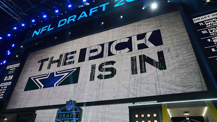 The Dallas Cowboys logo is projected on the video board during the NFL Draft at Lambeau Field.
