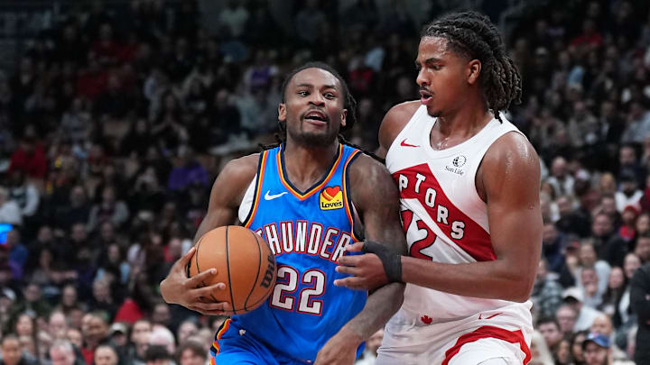Feb 24, 2026; Toronto, Ontario, CAN; Oklahoma City Thunder guard Cason Wallace (22) dribbles against Toronto Raptors forward Collin Murray-Boyles (12) during the fourth quarter at Scotiabank Arena.