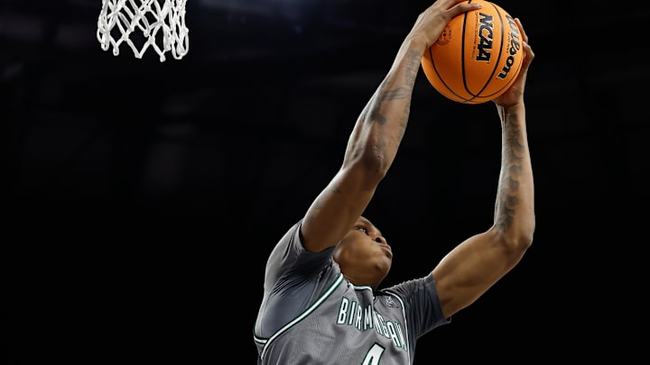 Mar 15, 2025; Fort Worth, TX, USA;  UAB Blazers forward Christian Coleman (4) grabs a rebound against North Texas Mean Green forward Grant Newell (8) during the first half at Dickies Arena. Mandatory Credit: Chris Jones-Imagn Images