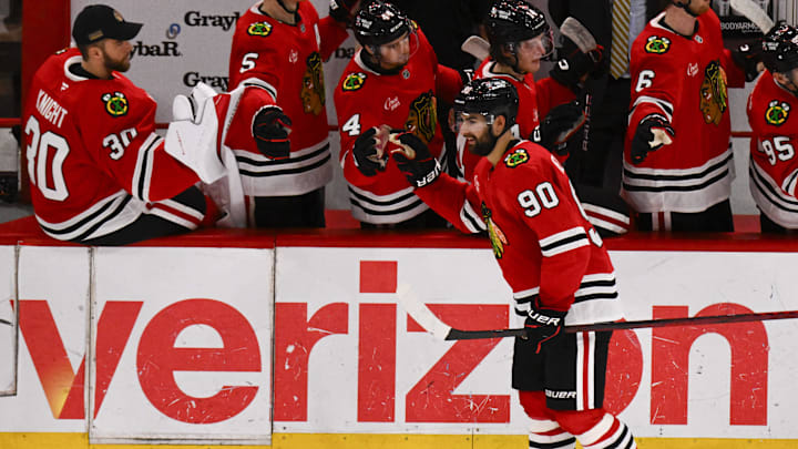 Mar 30, 2025; Chicago, Illinois, USA;  Chicago Blackhawks center Joe Veleno (90) celebrates with teammates  after he scores against Utah Hockey Club during the second period at United Center. Mandatory Credit: Matt Marton-Imagn Images
