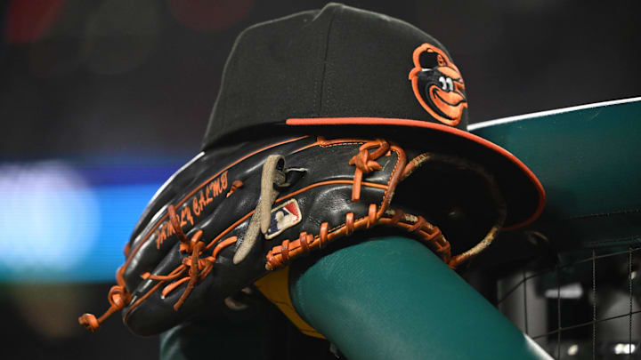 May 8, 2024; Washington, District of Columbia, USA; A Baltimore Orioles hat and glove rest on the dugout rail during a game against the Washington Nationals at Nationals Park. May 8, 2024; Washington, District of Columbia, USA; A Baltimore Orioles hat and glove rest on the dugout rail during a game against the Washington Nationals at Nationals Park.
