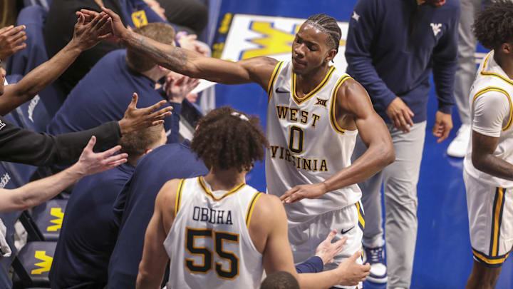 Mar 6, 2026; Morgantown, West Virginia, USA; West Virginia Mountaineers forward Brenen Lorient (0) celebrates with teammates during the first half against the UCF Knights at Hope Coliseum. Mandatory Credit: Ben Queen-Imagn Images