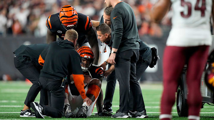 Cincinnati Bengals offensive tackle Trent Brown (77) is assisted off the field by the medical staff in the second quarter of the NFL Week 3 game between the Cincinnati Bengals and the Washington Commanders at Paycor Stadium in downtown Cincinnati on Monday, Sept. 23, 2024. The Commanders led 21-13 at halftime.