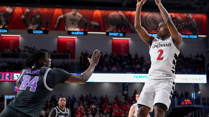 Cincinnati Bearcats guard Jizzle James (2) shoots a fade away basket in the second half of the NCAA Big 12 basketball game between the Cincinnati Bearcats and the Kansas State Wildcats at Fifth Third Arena in Cincinnati on Saturday, March 2, 2024. The Bearcats collected a 74-72 conference win. Cincinnati Bearcats guard Jizzle James (2) shoots a fade away basket in the second half of the NCAA Big 12 basketball game between the Cincinnati Bearcats and the Kansas State Wildcats at Fifth Third Arena in Cincinnati on Saturday, March 2, 2024. The Bearcats collected a 74-72 conference win.