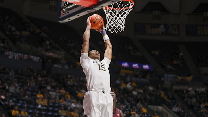 Dec 9, 2025; Morgantown, West Virginia, USA; West Virginia Mountaineers forward Jackson Fields (15) attempts to dunk the ball during the second half against the Little Rock Trojans at Hope Coliseum. Mandatory Credit: Ben Queen-Imagn Images