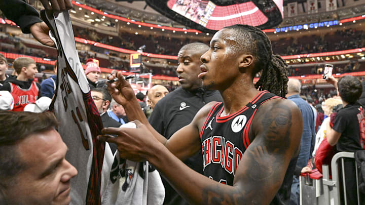 Jan 27, 2025; Chicago, Illinois, USA;  Chicago Bulls guard Ayo Dosunmu (11) signs autographs after a game against the Denver Nuggets at the United Center. Mandatory Credit: Matt Marton-Imagn Images