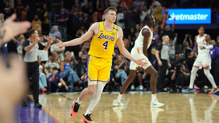 Oct 17, 2024; Phoenix, Arizona, USA; Los Angeles Lakers guard Dalton Knecht (4) reacts after making a three point basket against the Phoenix Suns during the overtime period at Footprint Center. Mandatory Credit: Joe Camporeale-Imagn Images