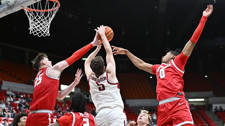 Oct 25, 2025; Pullman, WA, USA; Washington State Cougars guard Tomas Thrastarson (5) rebounds the ball against New Mexico Lobos center JT Rock (35) and guard Kevin Patton Jr. (0) in the first half at Friel Court at Beasley Coliseum. Mandatory Credit: James Snook-Imagn Images