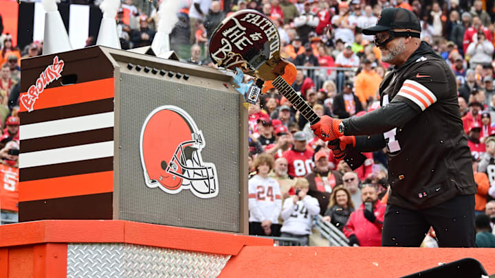 Oct 15, 2023; Cleveland, Ohio, USA; Former Cleveland Browns kicker Phil Dawson smashes a guitar with