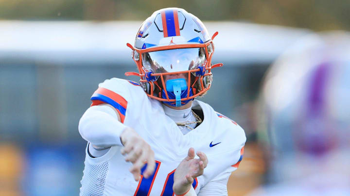Bolles' Ethan Drumm (10) throws the ball to Emmett Grzebin (28) during the first quarter of a high school football matchup Friday, Aug. 30, 2024 at Trinity Christian Academy in Jacksonville, Fla. The Bolles Bulldogs defeated the Trinity Christian Conquerors 41-7.