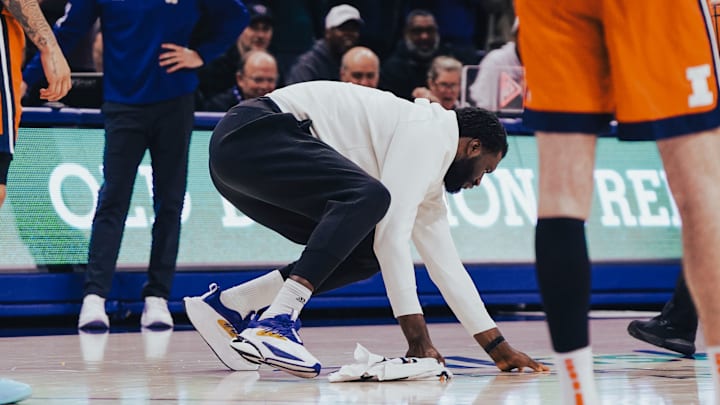 Franck Kepnang wipes up a wet spot on the floor. Franck Kepnang wipes up a wet spot on the floor.