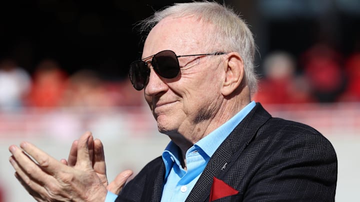 \Dallas Cowboys owner and member of the 1964 Arkansas Razorbacks National Championship team, Jerry Jones, claps as the team is honored during the first half against the Texas Longhorns at Donald W. Reynolds Razorback Stadium. 