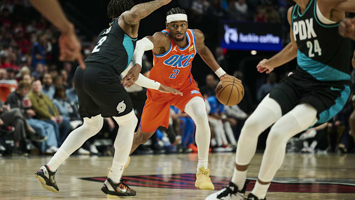 Nov 30, 2025; Portland, Oregon, USA; Oklahoma City Thunder guard Shai Gilgeous-Alexander (2) drives to the basket during the first half against Portland Trail Blazers guard Caleb Love (2) at Moda Center. Mandatory Credit: Troy Wayrynen-Imagn Images