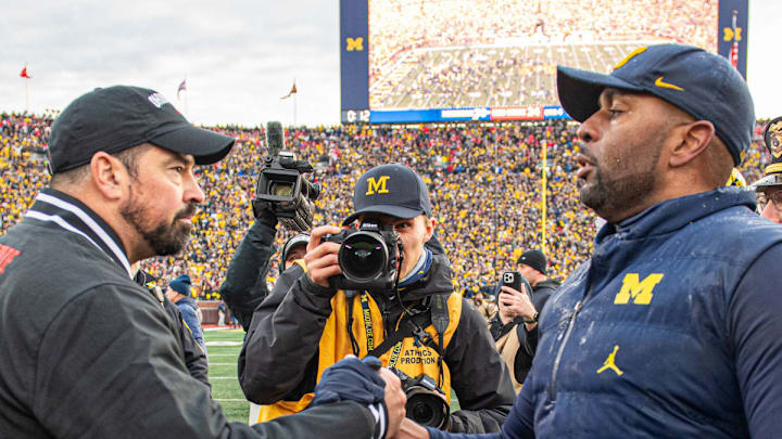 Michigan's Sherrone Moore and Ohio State's Ryan Day meet at mid-field
