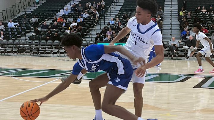 St. Mary’s guard Chase Collier (left) is hounded by Mount Carmel’s Sammartine Hill during Thursday’s Baltimore Catholic League Tournament quarterfinals. The Cougars, ranked No. 1 in the latest SI on High Schools Maryland Top 25, advanced with a 61-45 decision at Loyola University.