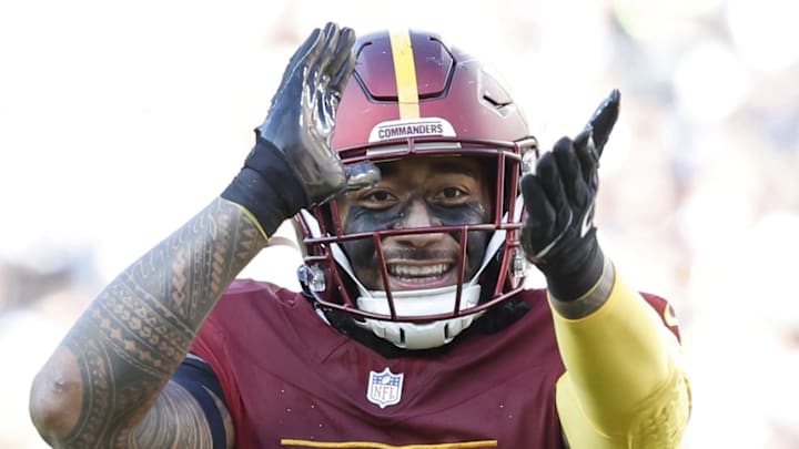 Nov 24, 2024; Landover, Maryland, USA; Washington Commanders linebacker Frankie Luvu (4) gestures to fans in the stands after making a tackle against the Dallas Cowboys at Northwest Stadium. Mandatory Credit: Geoff Burke-Imagn Images