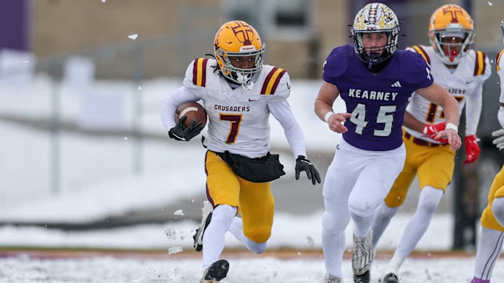 Lutheran North's Michael Clark runs away from a Kearney defender in a Class 4 semifinal game. Lutheran North's Michael Clark runs away from a Kearney defender in a Class 4 semifinal game.