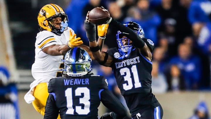 Kentucky Wildcats defensive back Maxwell Hairston (31) intercepts a pass intended for Missouri Tigers wide receiver Luther Burden III at Kroger Field Saturday on Oct. 14, 2023. The interception helped the Wildcats with a touchdown drive.