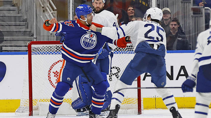 Feb 3, 2026; Edmonton, Alberta, CAN; Edmonton Oilers defensemen Darnell Nurse (25) and Toronto Maple Leafs defensemen Brandon Carlo (25) fight during the second period at Rogers Place. Mandatory Credit: Perry Nelson-Imagn Images