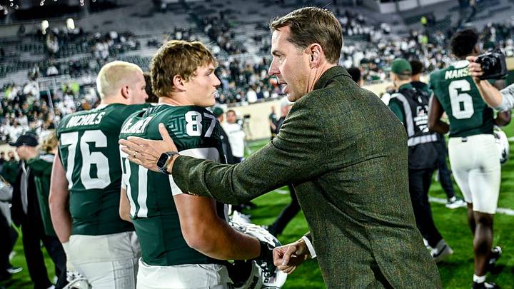 Michigan State's Athletic Director J Batt, right, congratulates players after the Spartans win over Western Michigan on Friday, Aug. 29, 2025, in East Lansing.