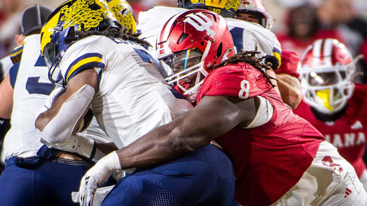 Indiana's CJ West (8) tackles Michigan's Donovan Edwards (7) during the Indiana versus Michigan football game at Memorial Stadium on Friday, Nov. 9, 2024. Indiana's CJ West (8) tackles Michigan's Donovan Edwards (7) during the Indiana versus Michigan football game at Memorial Stadium on Friday, Nov. 9, 2024.