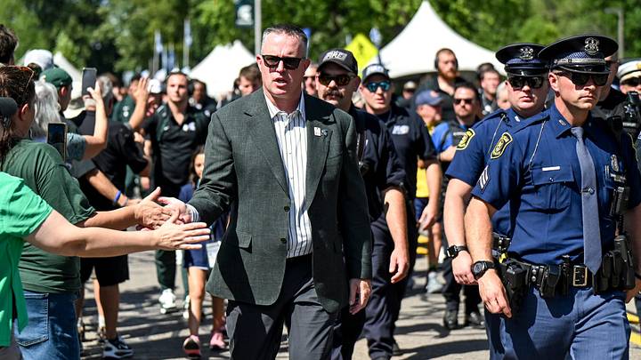 Michigan State’s head coach Pat Fitzgerald greets fans and the football team and first responders walk to Spartan Stadium before the game against Eastern Michigan on Saturday, Sept. 12, 2026, in East Lansing. Michigan State’s head coach Pat Fitzgerald greets fans and the football team and first responders walk to Spartan Stadium before the game against Eastern Michigan on Saturday, Sept. 12, 2026, in East Lansing.
