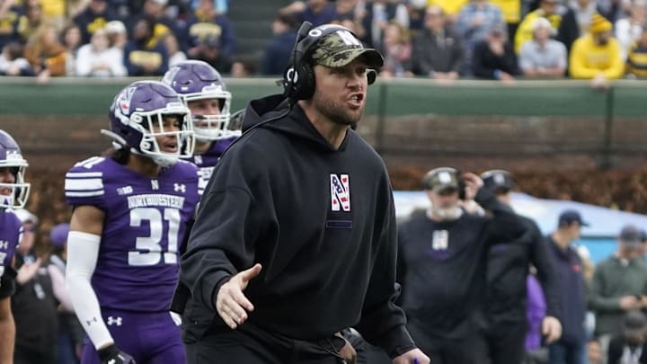 Nov 15, 2025; Chicago, Illinois, USA; Northwestern Wildcats head coach David Braun gestures to his team against the Michigan Wolverines during the first half at Wrigley Field. Mandatory Credit: David Banks-Imagn Images