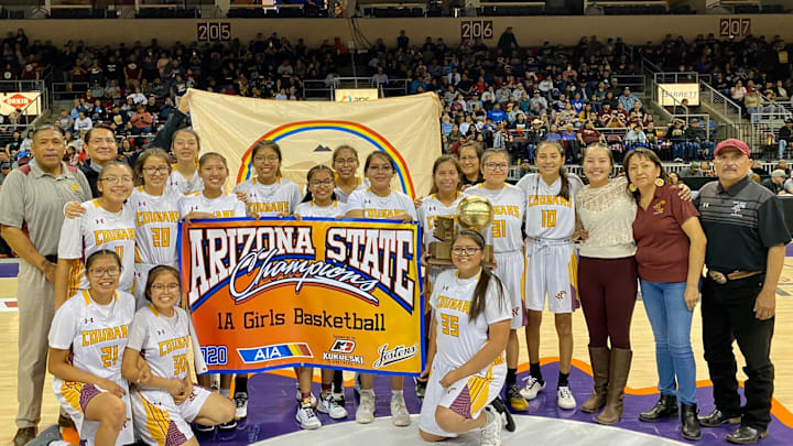 Feb. 22, 2020; Rock Point girls basketball team holds up the AIA 1A girls basketball championship title banner and trophy at Findlay Toyota Center in Prescott Valley, Ariz.

Rock Point girls basketball team