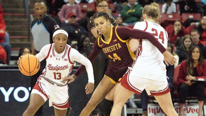 Wisconsin point guard Ronnie Porter (13) works around a screen set by Natalie Leuzinger (24) as Minnesota's Tori McKinney defends during a game at the Kohl Center in Madison, Wisconsin on Tuesday Dec. 31, 2024.