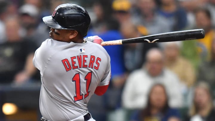 May 28, 2025; Milwaukee, Wisconsin, USA; Boston Red Sox designated hitter Rafael Devers (11) hits a two run single during the fourth inning against the Milwaukee Brewers at American Family Field. Mandatory Credit: Patrick Gorski-Imagn Images
