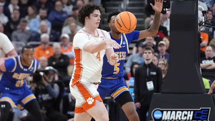 Mar 20, 2025; Providence, RI, USA; Clemson Tigers forward Ian Schieffelin (4) passes th ball against McNeese State Cowboys forward Joe Charles (5) during the first half at Amica Mutual Pavilion. Mandatory Credit: Gregory Fisher-Imagn Images
