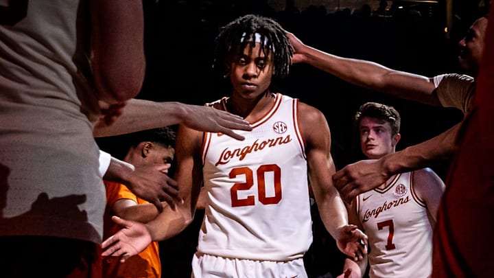 Texas Longhorns guard Tre Johnson (20) walks through a tunnel of teammates as the starting lineup is announced ahead of the Longhorns' game against the Sooners at the Moody Center in Austin, March 8, 2025. Texas Longhorns guard Tre Johnson (20) walks through a tunnel of teammates as the starting lineup is announced ahead of the Longhorns' game against the Sooners at the Moody Center in Austin, March 8, 2025.