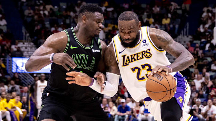 Apr 14, 2024; New Orleans, Louisiana, USA; Los Angeles Lakers forward LeBron James (23) dribbles against New Orleans Pelicans forward Zion Williamson (1) during the second half at Smoothie King Center.