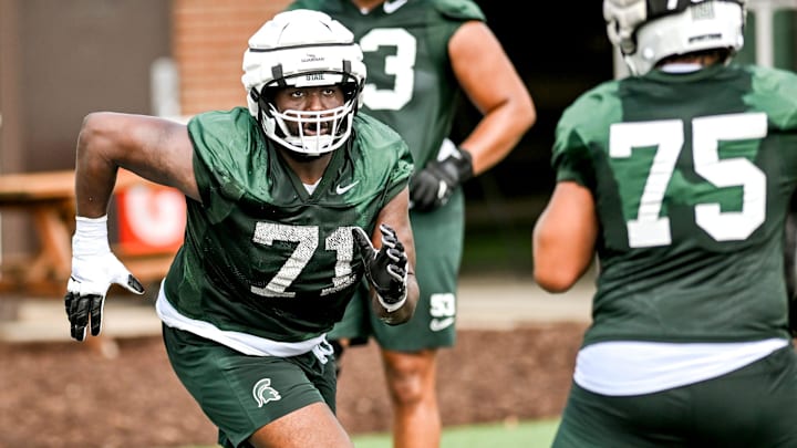 Michigan State's Kristian Phillips runs an offensive line drill during the first day of football camp on Tuesday, July 30, 2024, in East Lansing.