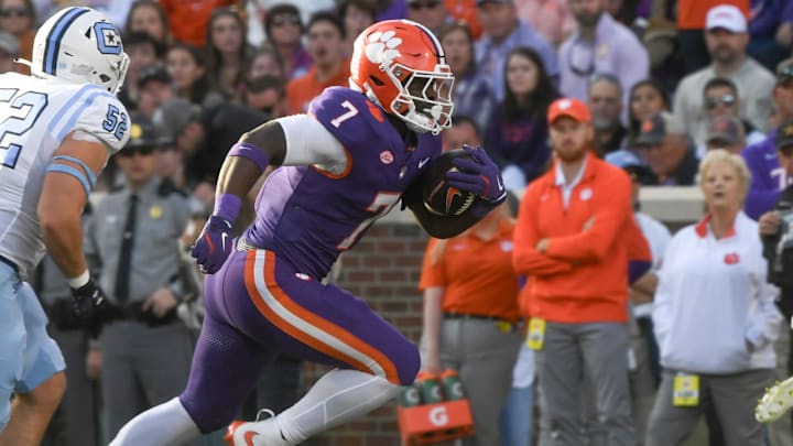 Nov 23, 2024; Clemson, South Carolina, USA; Clemson Tigers running back Phil Mafah (7) runs by The Citadel Bulldogs linebacker Camden Gray (52) during the first half at Memorial Stadium.
