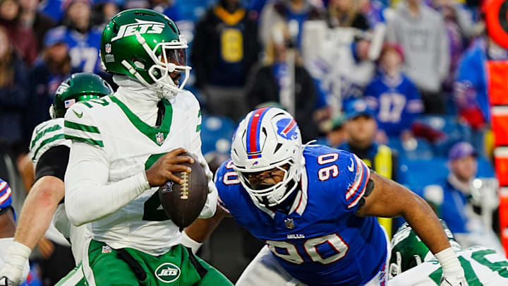 Buffalo Bills defensive tackle DeWayne Carter (90) heads towards New York Jets quarterback Tyrod Taylor (2) during second half action at the Bills home game against the New York Jets at Highmark Stadium in Orchard Park on Dec. 29, 2024.