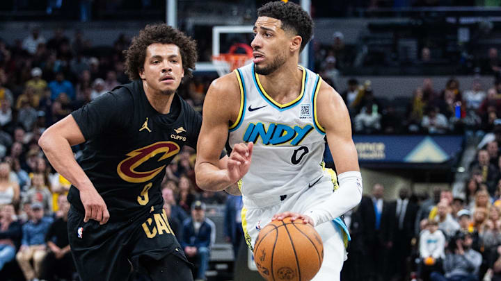 Apr 10, 2025; Indianapolis, Indiana, USA; Indiana Pacers guard Tyrese Haliburton (0) dribbles the ball while Cleveland Cavaliers guard Craig Porter Jr. (9) defends in the second half at Gainbridge Fieldhouse. Mandatory Credit: Trevor Ruszkowski-Imagn Images