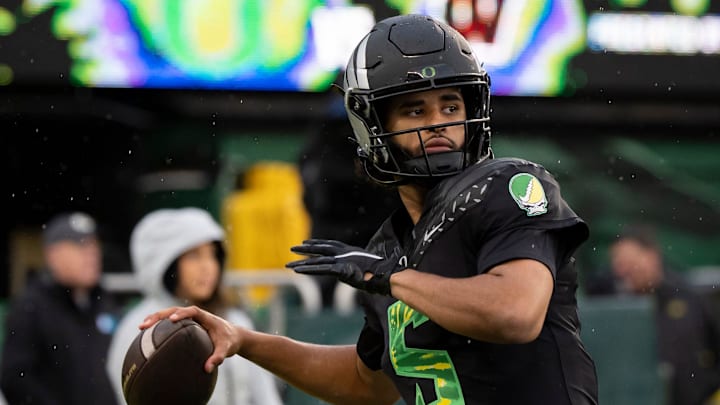 Oregon quarterback Dante Moore throws a pass before the game as the Oregon Ducks host the Wisconsin Badgers on Oct. 25, 2025, at Autzen Stadium in Eugene, Oregon. Oregon quarterback Dante Moore throws a pass before the game as the Oregon Ducks host the Wisconsin Badgers on Oct. 25, 2025, at Autzen Stadium in Eugene, Oregon.