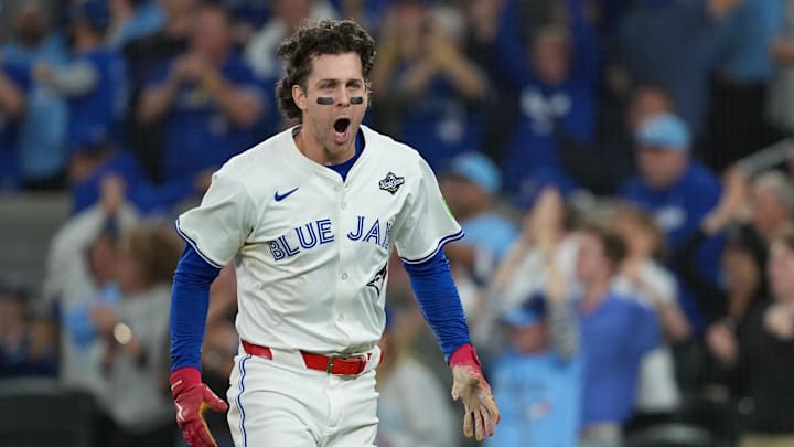 Nov 1, 2025; Toronto, Ontario, CAN; Toronto Blue Jays third baseman Ernie Clement (22) reacts after scoring a run against the Los Angeles Dodgers in the sixth inning for game seven of the 2025 MLB World Series at Rogers Centre. 