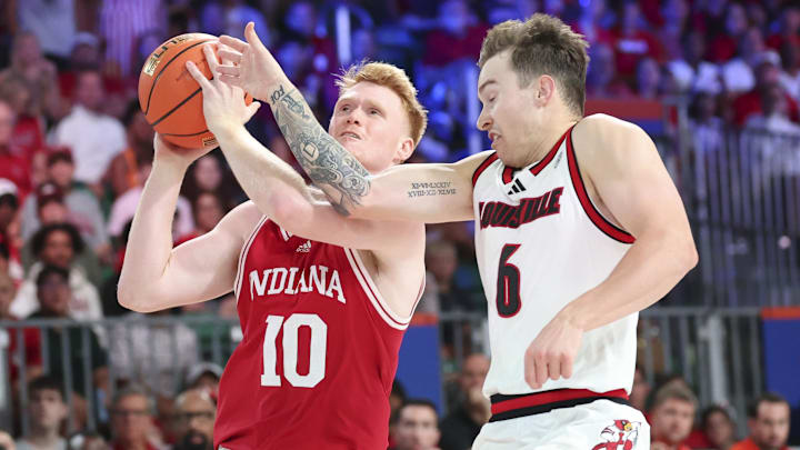 Indiana Hoosiers forward Luke Goode (10) drives to the basket as Louisville Cardinals guard Reyne Smith (6) defends during the second half at the Atlantis Resort. Indiana Hoosiers forward Luke Goode (10) drives to the basket as Louisville Cardinals guard Reyne Smith (6) defends during the second half at the Atlantis Resort.